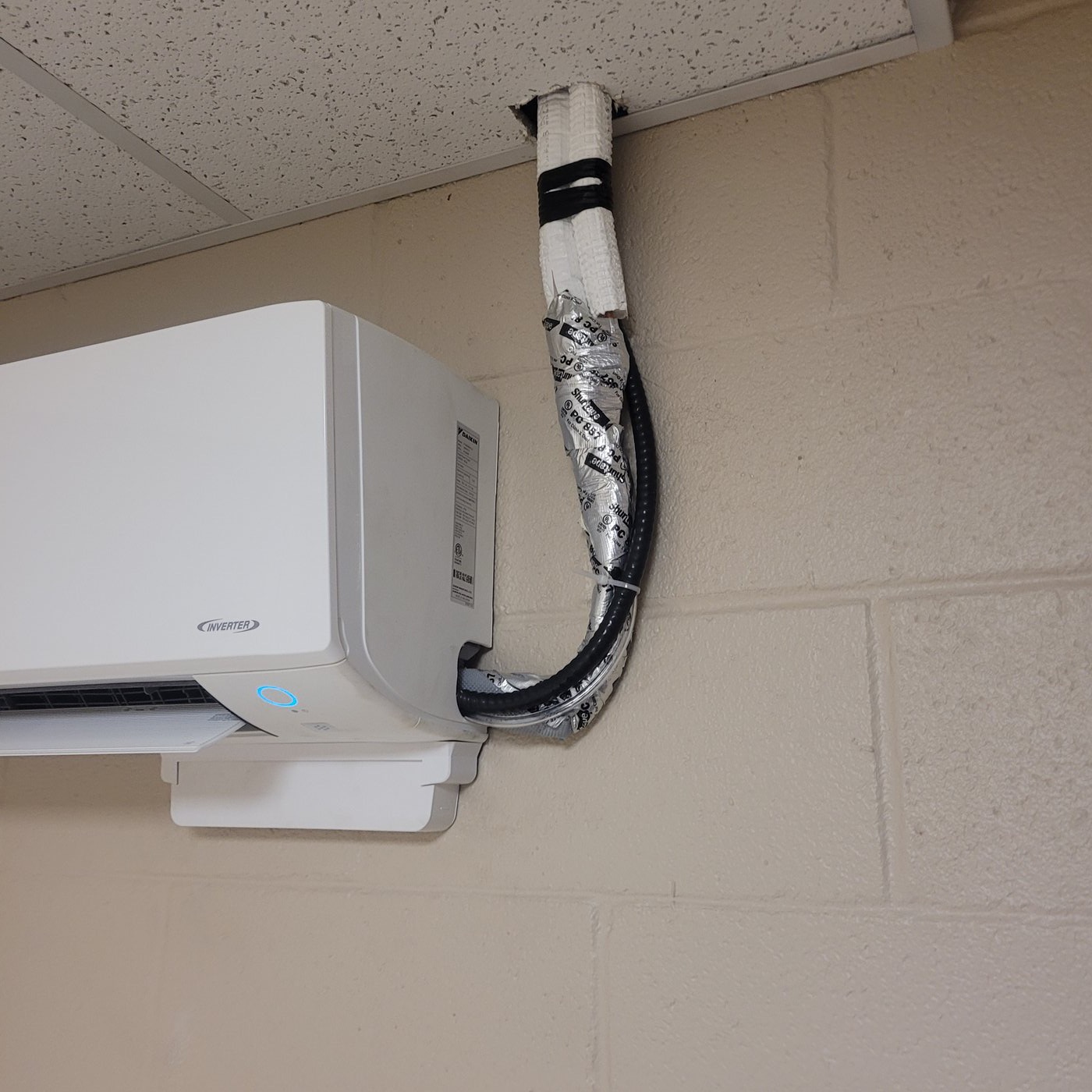 HVAC technician navigating tight clearances around ductwork